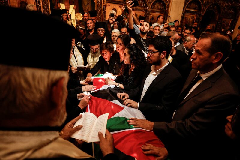 Family and friends stand by Abu Akleh's coffin during her funeral in a church in Jerusalem. Reuters