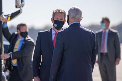 Vice President Mike Pence is greeted by Georgia Gov. Brian Kemp as he arrives at Dobbins Air Reserve Base in Marietta, Ga., Friday, Nov. 20, 2020. (Alyssa Pointer /Atlanta Journal-Constitution via AP)