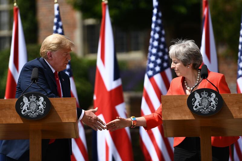 US President Donald Trump (L) and Britain's Prime Minister Theresa May shake hands at a press conference following their meeting at Chequers, the prime minister's country residence, near Ellesborough, northwest of London on July 13, 2018 on the second day of Trump's UK visit. US President Donald Trump launched an extraordinary attack on Prime Minister Theresa May's Brexit strategy, plunging the transatlantic "special relationship" to a new low as they prepared to meet Friday on the second day of his tumultuous trip to Britain. / AFP / Brendan Smialowski
