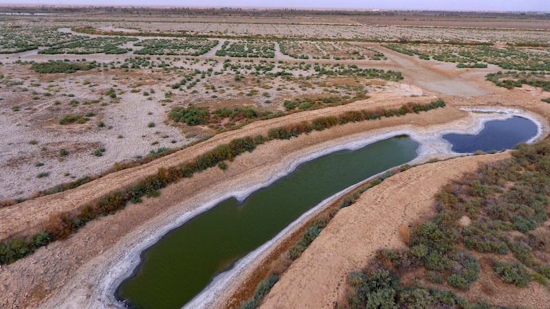 This Saturday, July 28, aerial photo shows a dry canal full of salt in the area of Siba in Basra, 340 miles (550 km) southeast of Baghdad, Iraq. Iraq, historically known as The Land Between The Two Rivers, is struggling with the scarcity of water due to dams in Turkey and Iran, lack of rain and aging hydrological infrastructure. The decreased water levels have greatly affected agriculture and animal resources. (AP Photo/Nabil al-Jurani)