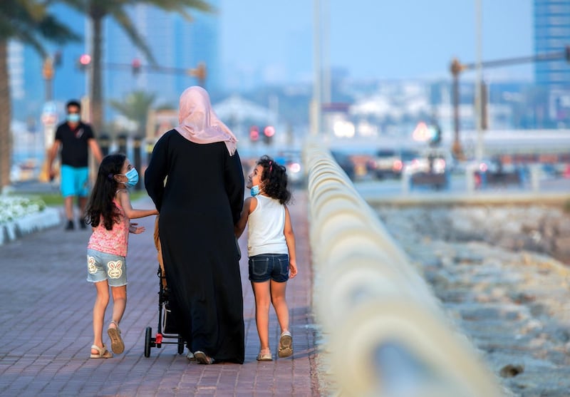 Abu Dhabi, United Arab Emirates, May 28, 2020.  A mother and her kids take a walk as the sun sets at the Corniche-Marina Mall pathway, Abu Dhabi.
Victor Besa  / The National
Section:  Standalone / Stock