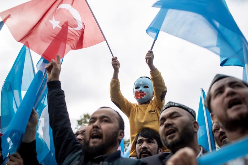 epa07145130 Turkish and Uyghur protesters shout slogans as they hold flags during a protest against China after prayers at Fatih Mosque in Istanbul, Turkey, 06 November 2018. Reports state people gathered to protest against what they claim to be Chinese continued use of internment camps to hold individuals primarily of the Uyghur ethnic group. The Uyghurs are a Turkic ethnic group, primarily Muslim, who have settled in the southwestern part of the Xinjiang Autonomous Region in northwest China, also known as East Turkestan.  EPA/SEDAT SUNA