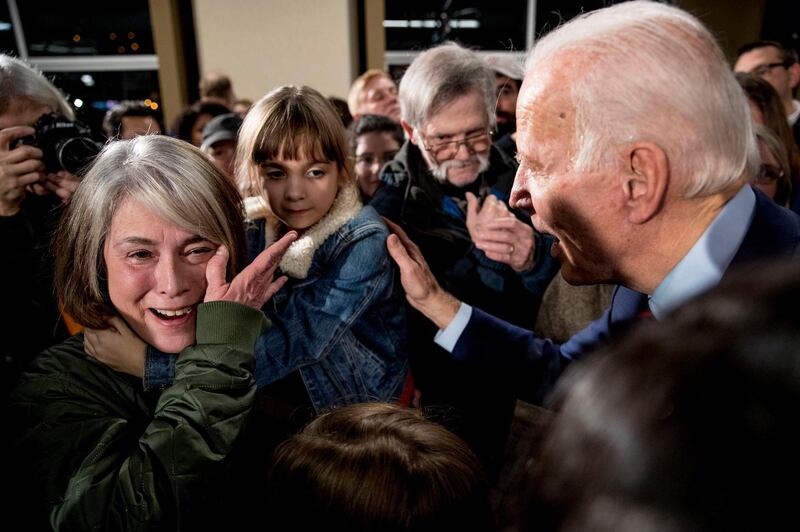 FILE - In this Jan. 5, 2020, file photo, Rose Boehle of Davenport, Iowa, becomes emotional as she and one of her granddaughters, Maddie, 7, speak with Democratic presidential candidate, former Vice President Joe Biden at a campaign rally at Modern Woodmen Park in Davenport, Iowa. Boehle is raising her granddaughters after her daughter overdosed on opioids. Though Biden's campaign has a policy paper on addiction, the issue has barely registered in this year's presidential campaign, overshadowed by the human and economic toll of the coronavirus outbreak and the Trump administration's response to the pandemic. (AP Photo/Andrew Harnik, File)