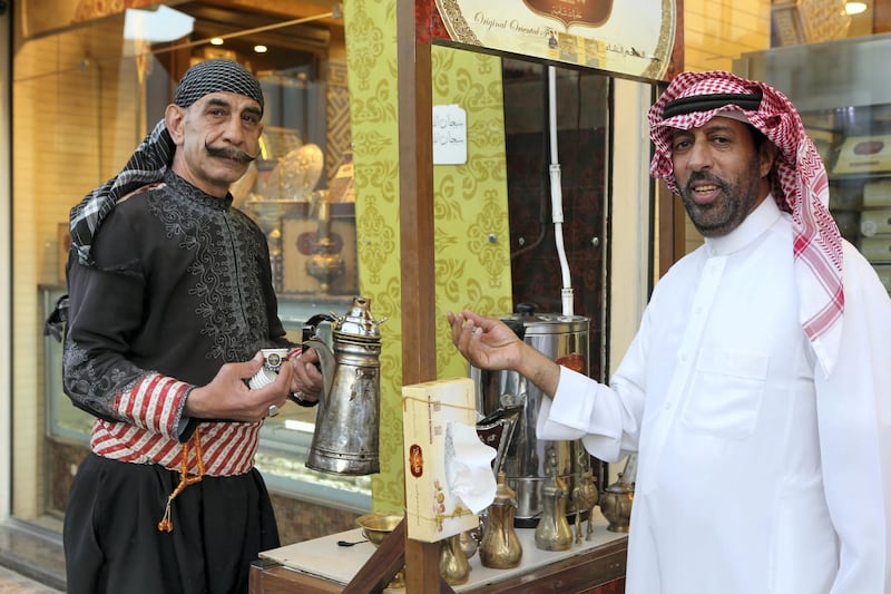 A Syrian man offers Arabic coffee at nafeesa in Amman, Jordan. (Salah Malkawi for The National)