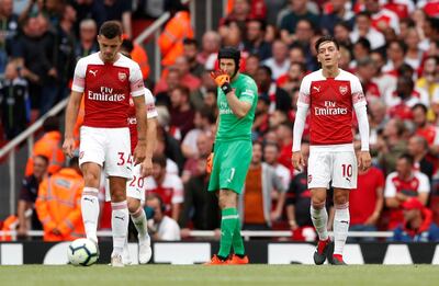 Soccer Football - Premier League - Arsenal v Manchester City - Emirates Stadium, London, Britain - August 12, 2018   Arsenal's Mesut Ozil, Petr Cech and Granit Xhaka look dejected after Manchester City scored their second goal   Action Images via Reuters/John Sibley    EDITORIAL USE ONLY. No use with unauthorized audio, video, data, fixture lists, club/league logos or "live" services. Online in-match use limited to 75 images, no video emulation. No use in betting, games or single club/league/player publications.  Please contact your account representative for further details.