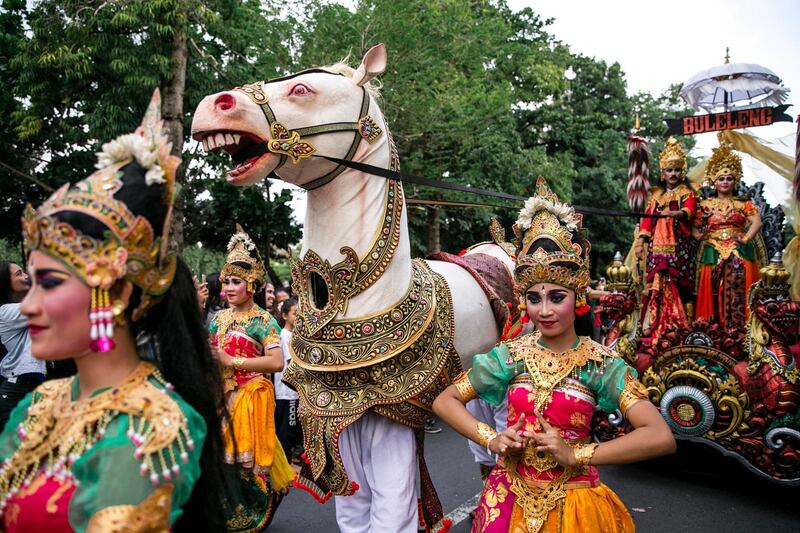 Balinese dancers take part in a parade to mark the opening of the annual Bali Art Festival on a main road in Denpasar, Bali, Indonesia.  Made Nagi / EPA