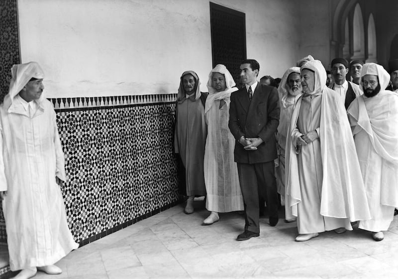 The Shah is accompanied by the rector of the Paris Mosque Si Kaddour Ben Ghabrit, second from right, during a visit to the mosque in August 1948. AFP