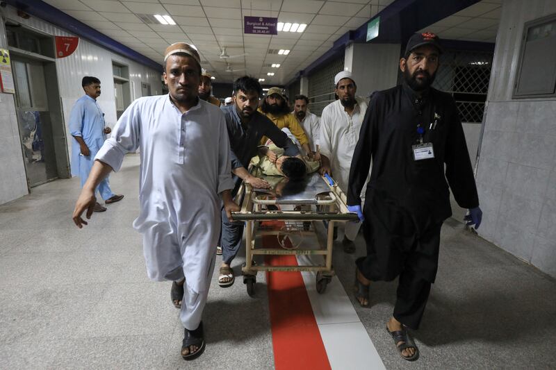 A wounded man is transported for treatment to the Lady Reading Hospital in Peshawar following a blast that killed at least 44 people in Bajaur, Pakistan. Reuters