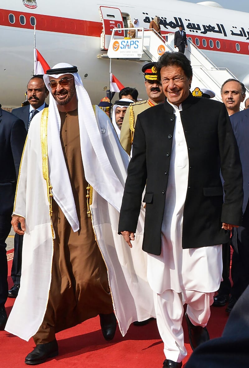 Pakistan's Prime Minister Imran Khan (R) walks with Abu Dhabi's Crown Prince Sheikh Mohamed bin Zayed Al-Nahyan (L) upon his arrival at the military Nur Khan Air Force base in Islamabad on January 6, 2019. The red carpet was rolled out for Abu Dhabi's Crown Prince Sheikh Mohamed bin Zayed Al-Nahyan in Islamabad on January 6, just weeks after his country offered $3 billion to support Pakistan's battered economy, local media said. / AFP / STR
