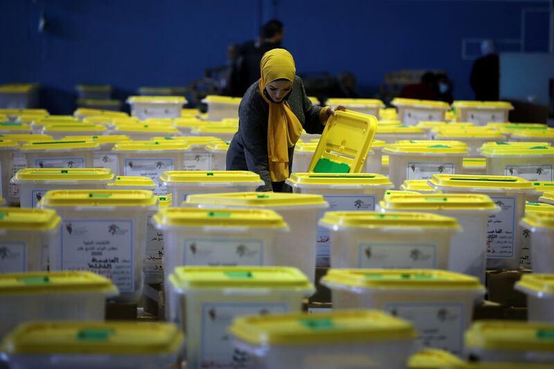 A Jordanian election official checks ballot boxes for the parliamentary elections which will be held on November 10, amid fears over rising number of the coronavirus disease (COVID-19) cases, at a vote counting center in Amman, Jordan November 8, 2020. REUTERS/Muhammad Hamed