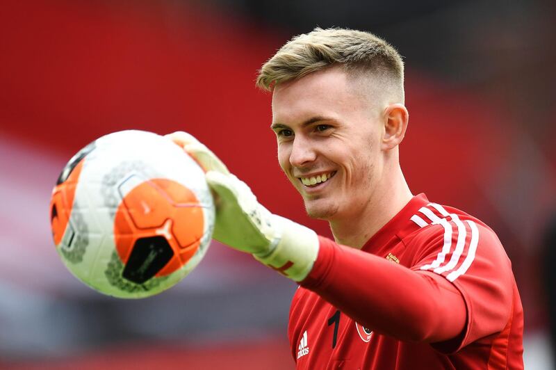 (FILES) In this file photo taken on July 20, 2020 Sheffield United's English goalkeeper Dean Henderson warms up prior to the  English Premier League football match between Sheffield United and Everton at Bramall Lane stadium in Sheffield, northern England. Goalkeeper Dean Henderson has signed a new long-term contract with Manchester United, the Premier League club announced on Wednesday, August 26. - RESTRICTED TO EDITORIAL USE. No use with unauthorized audio, video, data, fixture lists, club/league logos or 'live' services. Online in-match use limited to 120 images. An additional 40 images may be used in extra time. No video emulation. Social media in-match use limited to 120 images. An additional 40 images may be used in extra time. No use in betting publications, games or single club/league/player publications.
 / AFP / POOL / PETER POWELL / RESTRICTED TO EDITORIAL USE. No use with unauthorized audio, video, data, fixture lists, club/league logos or 'live' services. Online in-match use limited to 120 images. An additional 40 images may be used in extra time. No video emulation. Social media in-match use limited to 120 images. An additional 40 images may be used in extra time. No use in betting publications, games or single club/league/player publications.
