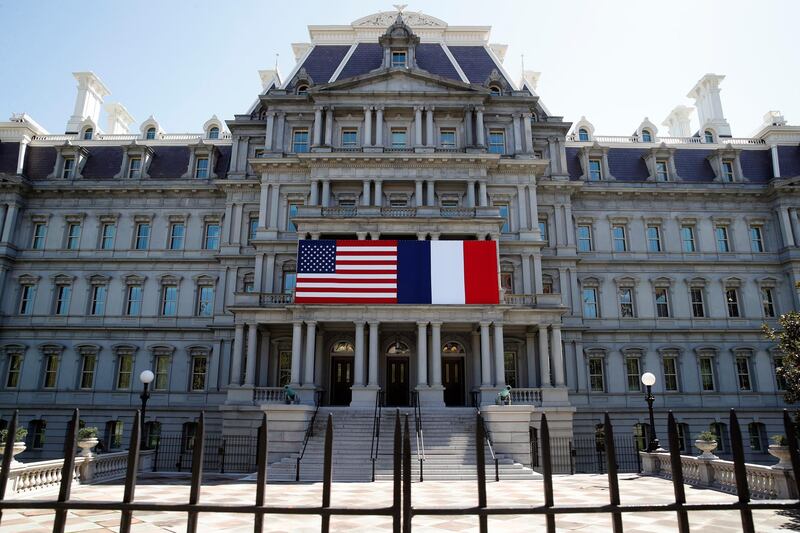 The U.S. and French flags are displayed on the Eisenhower Executive Office Building, Friday, April 20, 2018, in Washington. President Donald Trump plans to celebrate nearly 250 years of U.S.-French relations by hosting President Emmanuel Macron at a glitzy White House state dinner on Tuesday. Itâ€™s the first state visit and the first big soiree of the Trump era in Washington. (AP Photo/Alex Brandon)