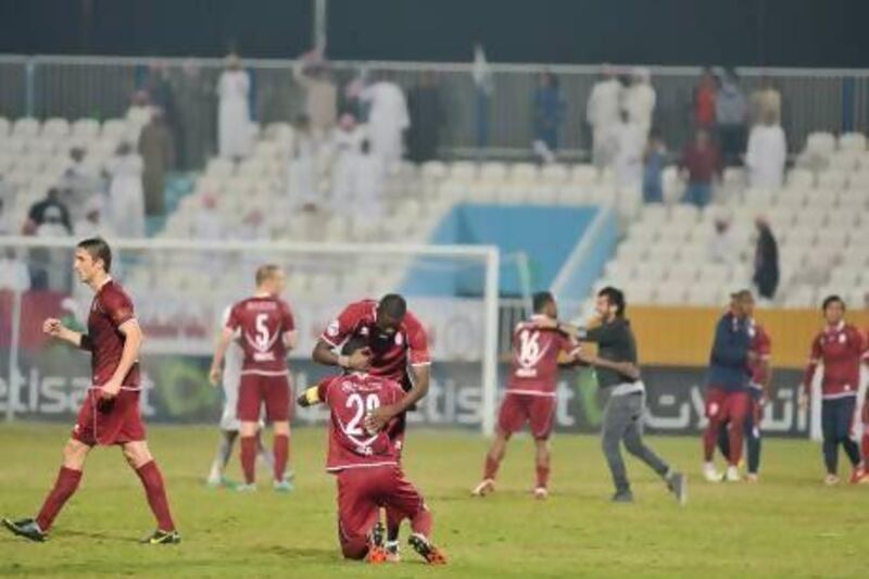 Al Wahda players celebrate substitute Saeed Al Kathiri's winner against Abu Dhabi rivals Al Jazira to advance to the semi-finals. Al Ittihad