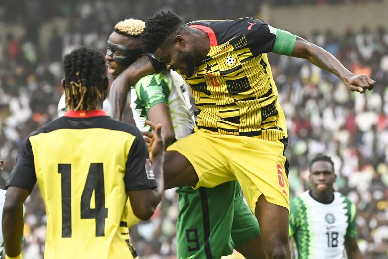 Ghana's Thomas Partey and Victor Osimhen challenge for a header. AFP