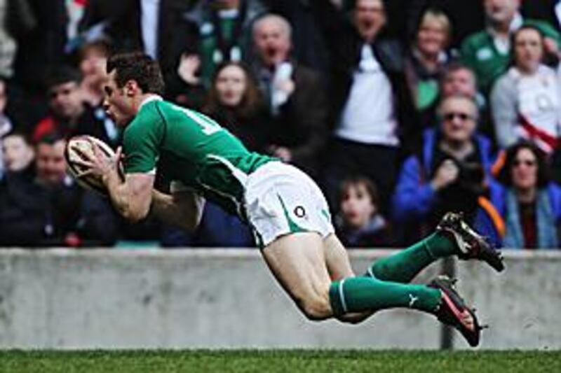 Tommy Bowe dives over for the first of his two tries at Twickenham yesterday.