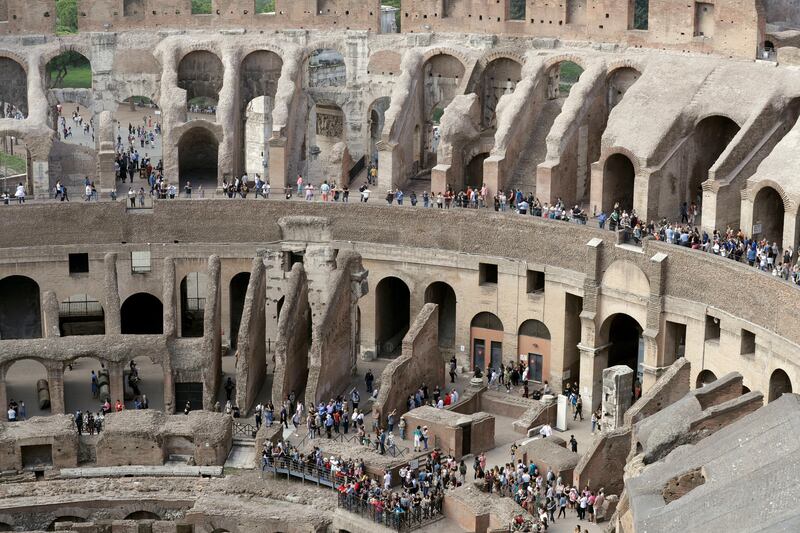 Tourists are seen visiting the ancient Colosseum as seen from the topmost floor. Andrew Medichini / AP Photo