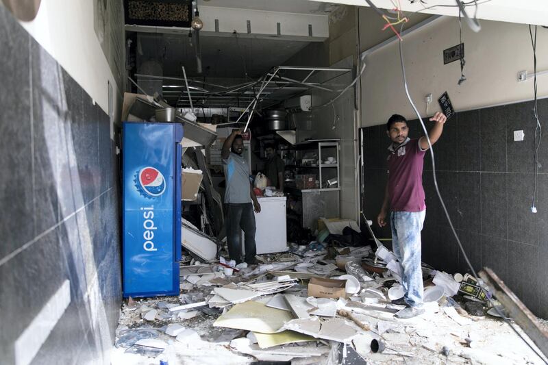 AJMAN, UNITED ARAB EMIRATES - JANUARY 23, 2019.

Men clear out items from  Feza Cafe, after a gas cylinder exploded on Tuesday in Feza Cafe in Ajman.

Five workers were injured and taken to Sheikh Khalifa Hospital after suffering moderate to severe injuries in the blast on Tuesday.

The cooking gas cylinder explosion demolished much of the cafe in the Al Rashidiya district. Fire crews and the ambulance service raced to the scene at about noon.

Lt Col Mustafa Sultan Al Ali of Ajman Civil Defence sent a safety warning to business owners after the incident.

“They should not store the gas cylinder inside the kitchen. It must be kept in a separate, well-ventilated box away from the kitchen and heat sources and should not be thrown or rolled down on the floor," he said.

"They also should make sure that the cylinder is sealed after use."


(Photo by Reem Mohammed/The National)

Reporter: SALAM AL AMIR
Section:  NA