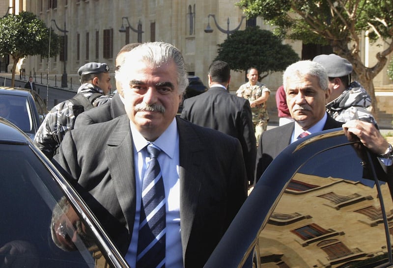 Rafik Hariri, left, and his bodyguard Yahya Arab, leave the Parliament in Beirut, Lebanon in 2005. Minutes later, Hariri and several of his bodyguards were killed in a massive bomb explosion.  AP
