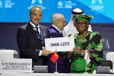 WTO Director general Ngozi Okonjo-Iweala and Timor-Leste Deputy Prime Minister Francisco Kalbuadi Lay sign the agreement for Timor-Leste's accession to the WTO in Abu Dhabi on Monday. AFP