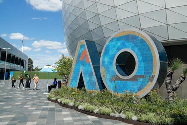 Spectators walk around Melbourne Park, the venue for the Australian Open. AP