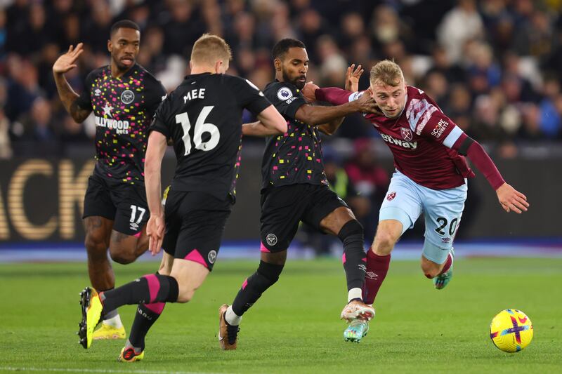 Jarrod Bowen of West Ham United is challenged by Rico Henry, Ivan Toney and Ben Mee of Brentford during the Premier League match at London Stadium on December 30, 2022 in London, England. Getty Images