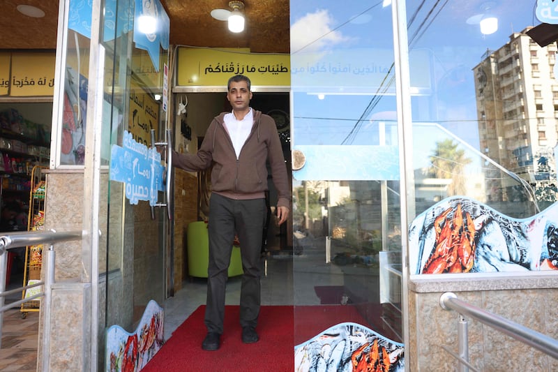 Mustapha Abu Hassira in front of his seafood shop in Gaza city. Many fishing families in the Palestinian enclave have abandoned their profession because of the financial hardships.