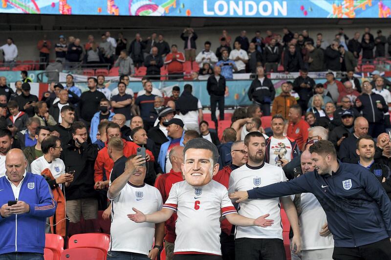 LONDON, ENGLAND - JUNE 18: An England fan wearing a large Harry Maguire face mask shows their support prior to the UEFA Euro 2020 Championship Group D match between England and Scotland at Wembley Stadium on June 18, 2021 in London, England. (Photo by Andy Rain - Pool/Getty Images)