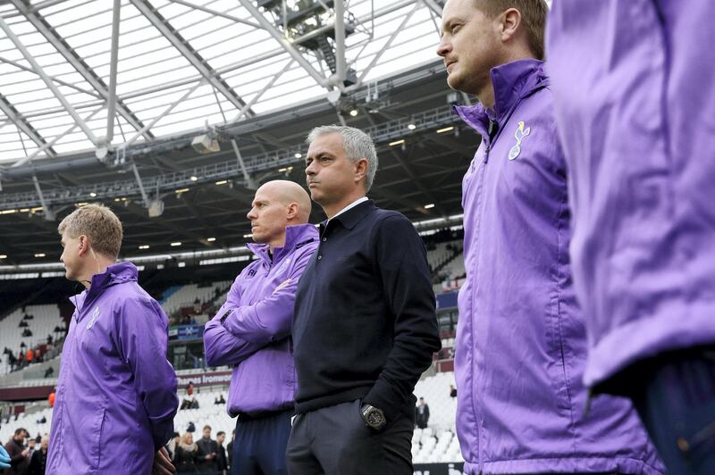 Tottenham Hotspur's Portuguese head coach Jose Mourinho (C) watches the players warm up before the start of the English Premier League football match between West Ham United and Tottenham Hotspur at The London Stadium, in east London on November 23, 2019. (Photo by Adrian DENNIS / AFP) / RESTRICTED TO EDITORIAL USE. No use with unauthorized audio, video, data, fixture lists, club/league logos or 'live' services. Online in-match use limited to 120 images. An additional 40 images may be used in extra time. No video emulation. Social media in-match use limited to 120 images. An additional 40 images may be used in extra time. No use in betting publications, games or single club/league/player publications. / 
