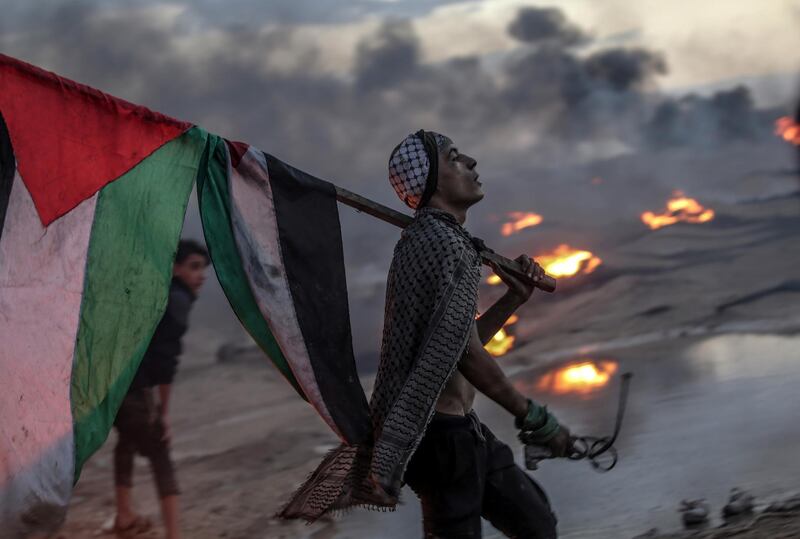 A Palestinian protester during clashes after protest near the border between Israel and the Gaza Strip. EPA