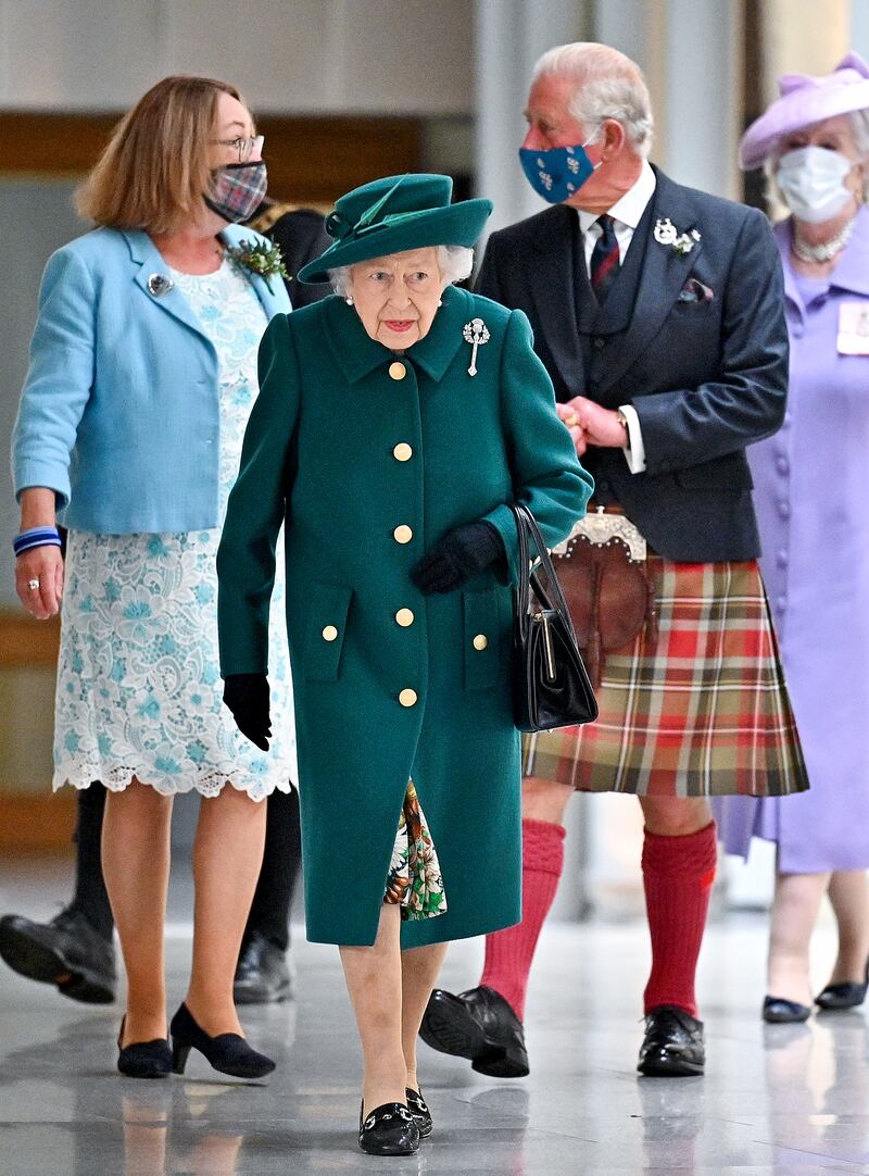 Queen Elizabeth II, wearing dark green, arrives for the opening of the sixth session of the Scottish Parliament on October 2, 2021, in Edinburgh. Getty Images