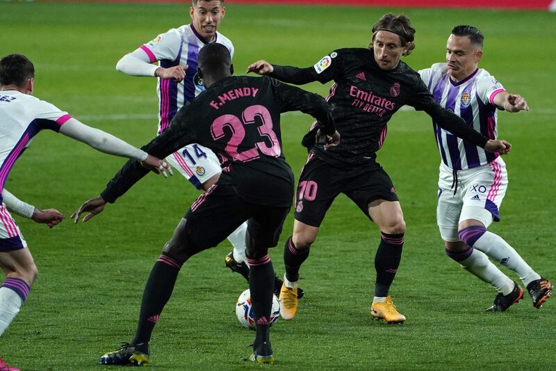 Real Madrid's Luka Modric vies with Real Valladolid's Roque Mesa. AFP