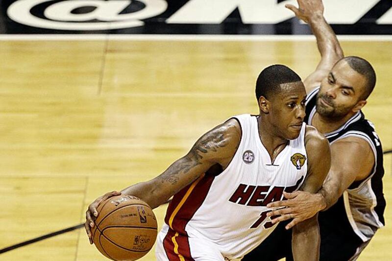 Miami Heat point guard Mario Chalmers (15) moves the ball against San Antonio Spurs point guard Tony Parker (9) during the second half of Game 2 in the NBA Finals basketball game,  Sunday, June 9, 2013 in Miami. The Miami Heat won 103-84. (AP Photo/Wilfredo Lee)
