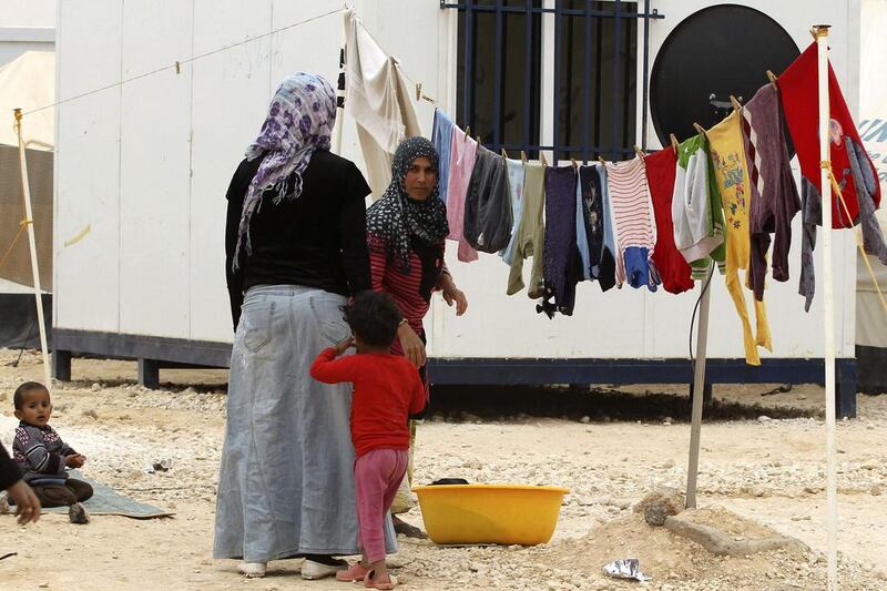 A Syrian woman refugee hangs her laundry at the Zaatari refugee camp in the Jordanian city of Mafraq, near the border with Syria. Muhammad Hamed / Reuters / March 8, 2014