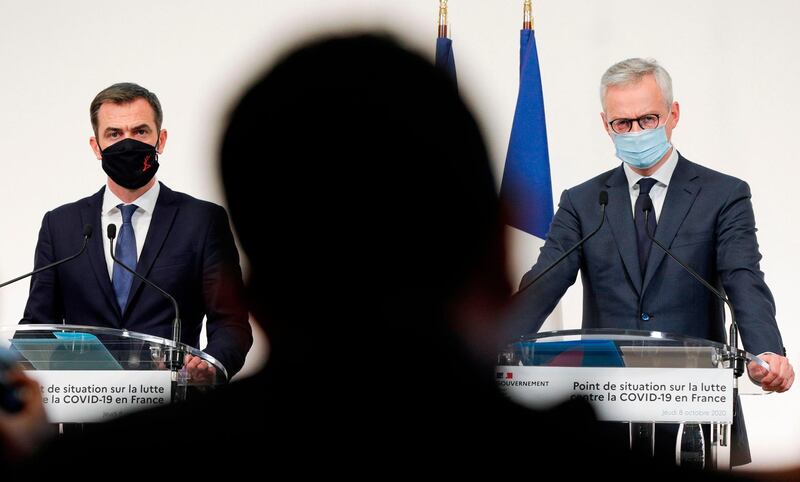 French Economy and Finance Minister Bruno Le Maire (R) and French Health Minister Olivier Veran, wearing protective masks, look on during a press conference about the situation of the Covid-19 pandemic caused by the novel coronavirus in France, at the Health Ministry in Paris. AFP