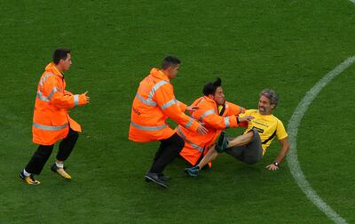 Soccer Football - La Liga Santander - FC Barcelona vs Las Palmas - Camp Nou, Barcelona, Spain - October 1, 2017   Man is tackled by security after invading the pitch    REUTERS/Albert Gea