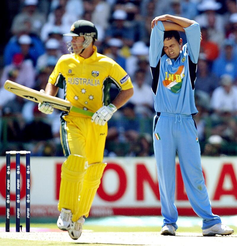Australian captain Ricky Ponting takes another run as Indian bowler Dinesh Mongia (R) looks in pain in the final of the ICC Cricket World Cup being played at the Wanderers Stadium in Johannesburg 23 March 2003.  Batting first, Australia scored 359-2 from their 50 overs, their highest ever one-day total.  AFP PHOTO/William WEST (Photo by WILLIAM WEST / AFP)