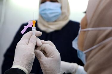 A medic prepares a Covid-19 vaccine injection. AFP