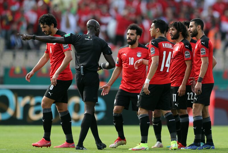 Mohamed Salah and his Egypt teammates argue with referee Maguette Ndiaye. Reuters