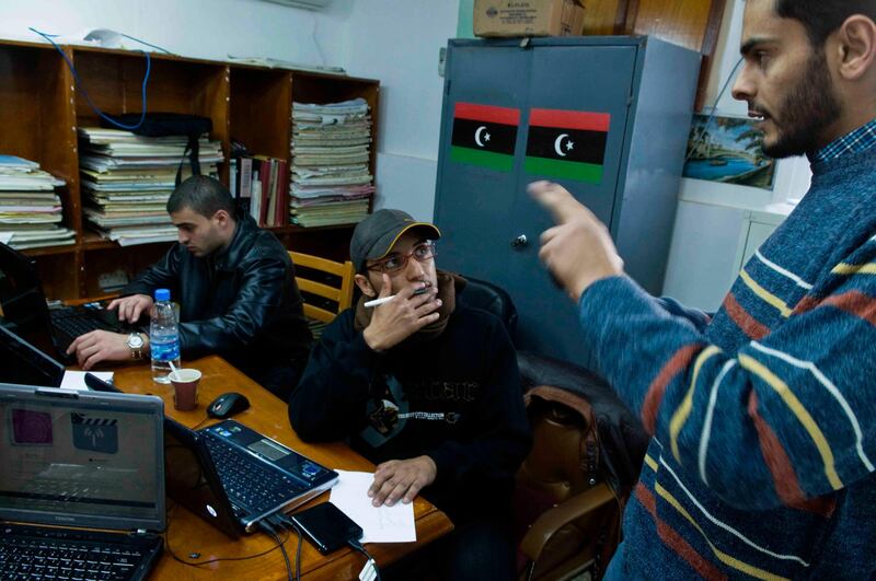 February 26, 2011, Benghazi, Libya:  Libyans working to upload cell phone footage online in Benghazi, Libya on Friday, February 26, 2011. The courthouse has been turned into an opposition headquarters.   . Credit: Ted Nieters / Polaris Credit should read : Ted Nieters/Polaris for The National