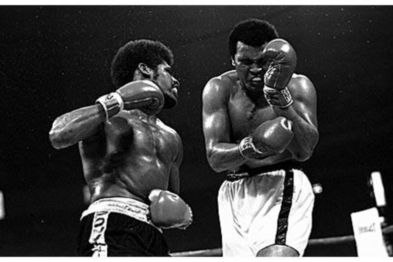 Muhammad Ali grimaces as Leon Spinks lands a hard left and gets ready to unload with his right fist.