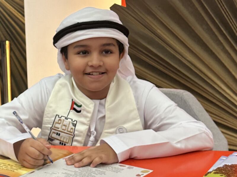 Schoolboy environmentalist Sultan Albadi, from Sharjah, signing his third book. Photo: Sultan Albadi