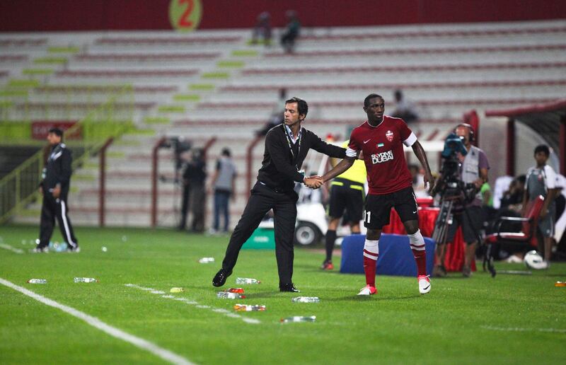 Dubai, UAE, December 6 2012: 

Al Ahli and FC Dibba battled it out tonight at the Rashid Stadium. Al Ahli came out on top, winning 1-0.

Al Ahli's head coach congratulates a player on his game after being substiuted late in the second half.

Lee Hoagland/The National