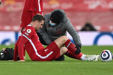 FILE PHOTO: Soccer Football - Premier League - Liverpool v Everton - Anfield, Liverpool, Britain - February 20, 2021 Liverpool's Jordan Henderson receives medical attention after sustaining an injury Pool via REUTERS/Laurence Griffiths EDITORIAL USE ONLY. No use with unauthorized audio, video, data, fixture lists, club/league logos or 'live' services. Online in-match use limited to 75 images, no video emulation. No use in betting, games or single club /league/player publications. Please contact your account representative for further details./File Photo