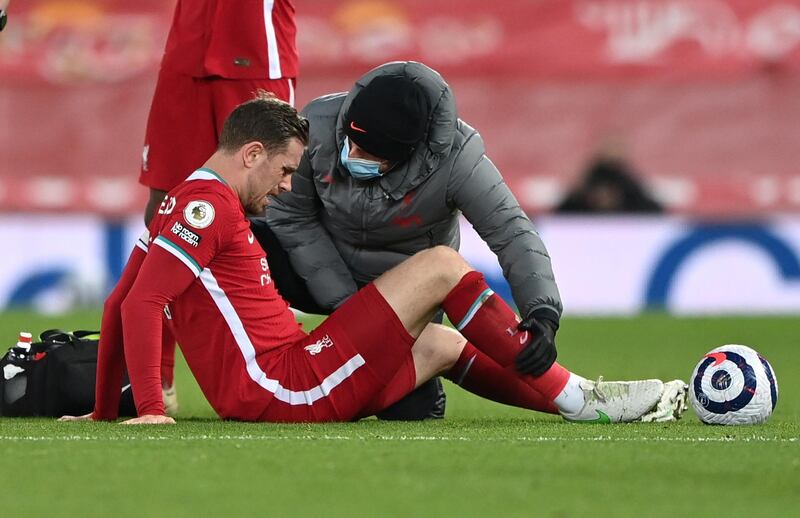 FILE PHOTO: Soccer Football - Premier League - Liverpool v Everton - Anfield, Liverpool, Britain - February 20, 2021 Liverpool's Jordan Henderson receives medical attention after sustaining an injury Pool via REUTERS/Laurence Griffiths EDITORIAL USE ONLY. No use with unauthorized audio, video, data, fixture lists, club/league logos or 'live' services. Online in-match use limited to 75 images, no video emulation. No use in betting, games or single club /league/player publications.  Please contact your account representative for further details./File Photo