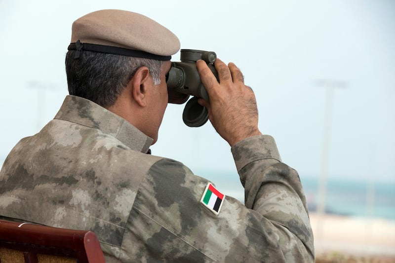 AL DHAFRA REGION, ABU DHABI, UNITED ARAB EMIRATES - April 08, 2018: HE Major General Mohamed Khalfan Al Romaithi, Commander in Chief of Abu Dhabi Police and Head of Security, Justice, Health and Safety Committee of Abu Dhabi Executive Council (C), witnesses a military exercise titled ‘Homat Al Watan 2 (Protectors of the Nation)’, at Al Hamra Camp.

( Hamad Al Mansouri for Crown Prince Court - Abu Dhabi )
---