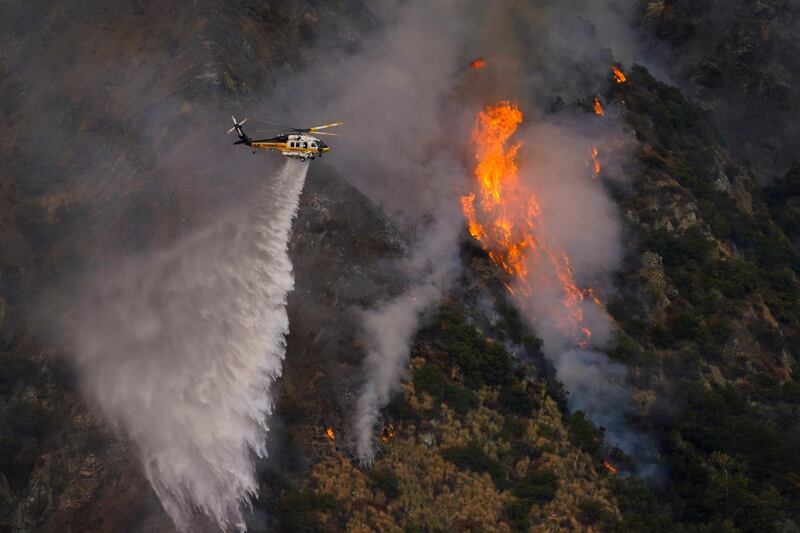 A helicopter makes a water drop over the Ranch Fire in Azusa, California. AP Photo