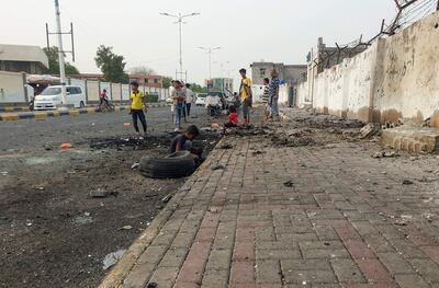 People gather around the site of a reported explosion in the Khormaksar area of Yemen's southern city of Aden, on June 29, 2022.  (Photo by Saleh OBAIDI  /  AFP)