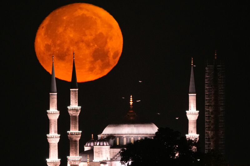 A supermoon sets behind the Ottoman-era Sultan Ahmed or Blue Mosque in Istanbul, Turkey. AP Photo