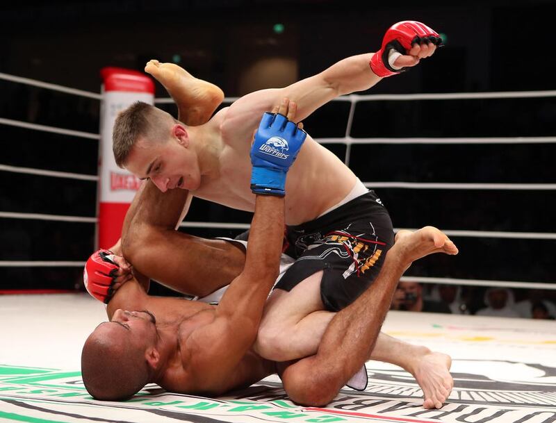 The UAE’s Ahmad Al Darmaki, in white shorts, fights with Artiyom Gorodynets from Ukraine in the Abu Dhabi Warriors 4 at IPIC Arena in Zayed Sports city in Abu Dhabi. Ravindranath K / The National