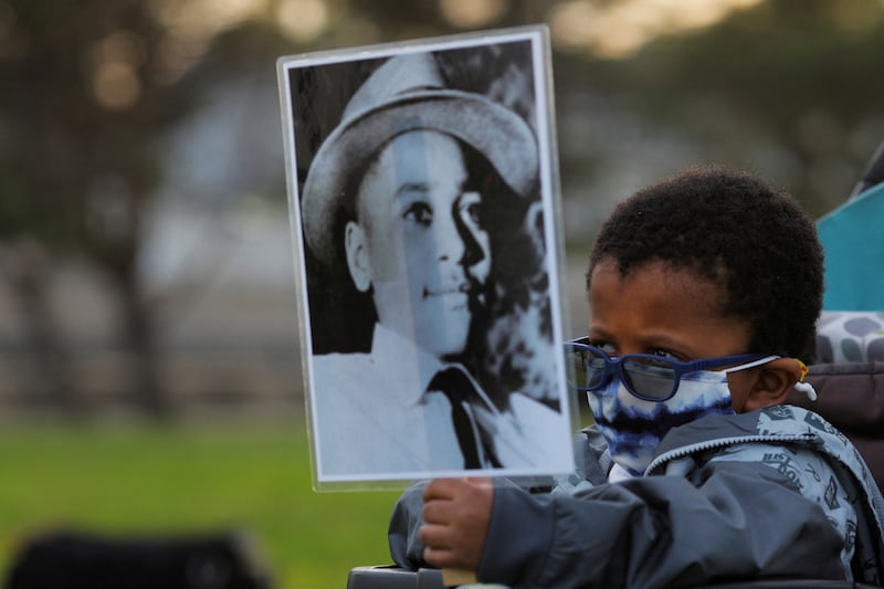 Four-year-old Senty Banutu-Gomez holds a photograph of Emmett Till, a 14-year-old black boy who was lynched in 1955, on the anniversary of the murder of George Floyd by police in Minneapolis, Minnesota. Reuters